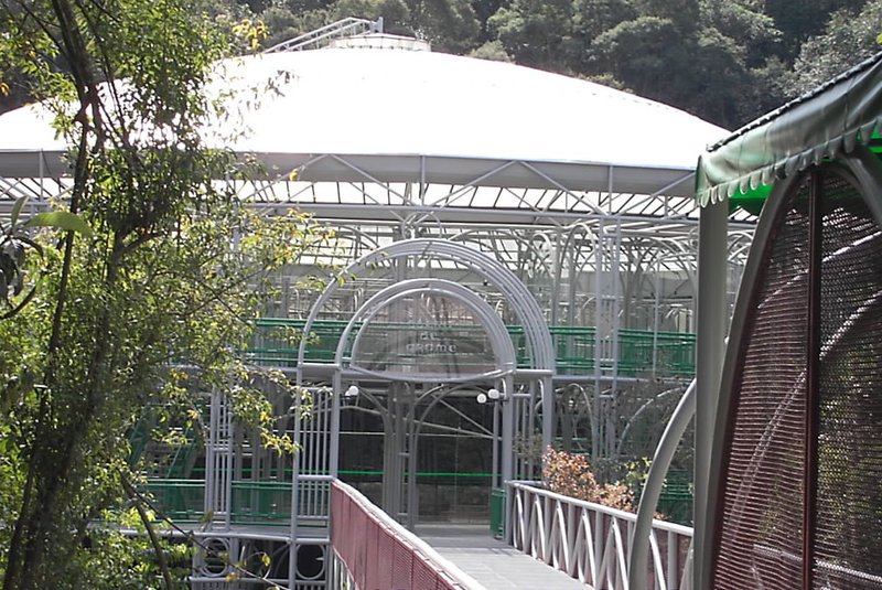 Wire-mesh dome of the Ópera de Arame reflected in a flooded limestone quarry